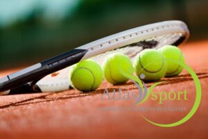 Close up view of tennis racket and balls on the clay tennis court